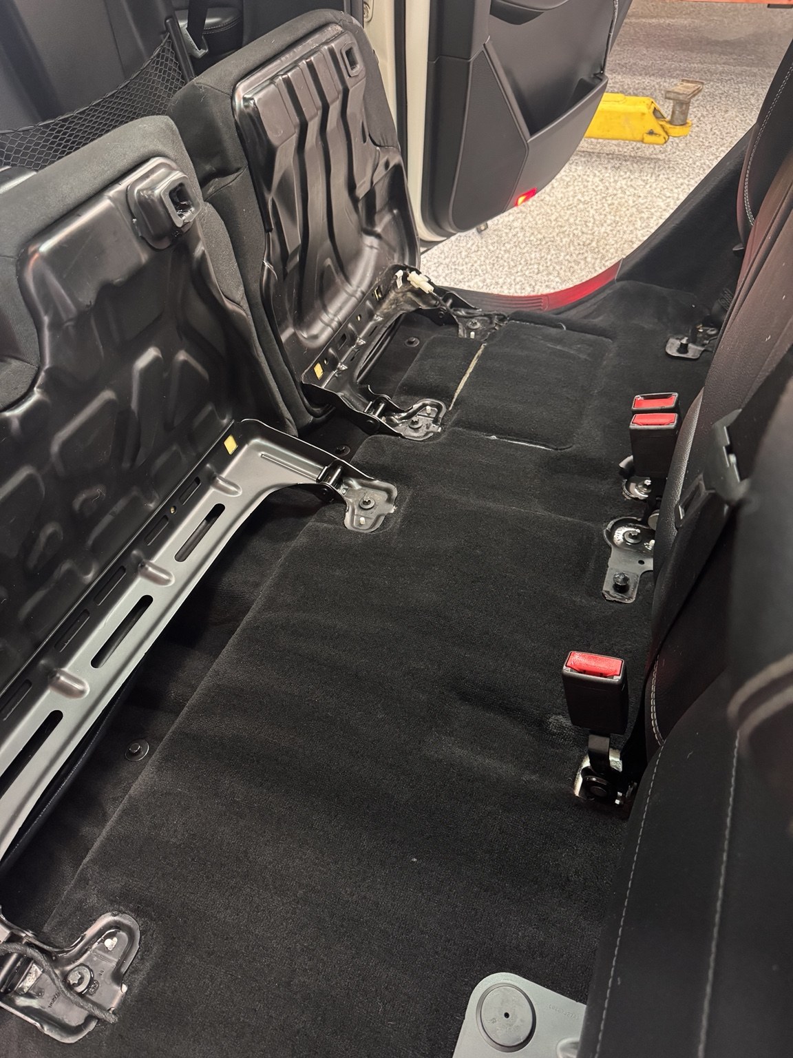 After detailing: cleaned rear vehicle carpet with visible vacuum lines
