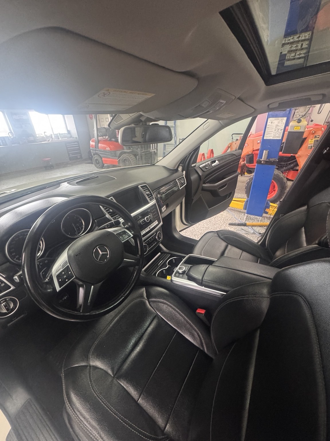 Finished black leather vehicle interior after detailing