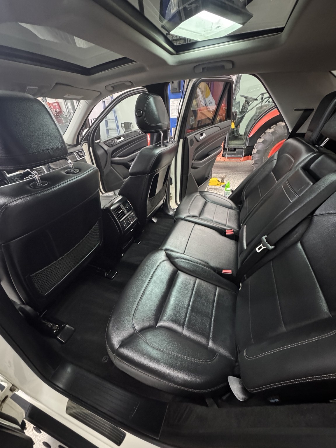 Finished detailing result showing black leather rear seats and interior
