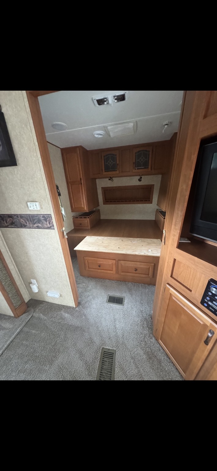 RV bedroom area and carpet after cleaning, with the mattress removed