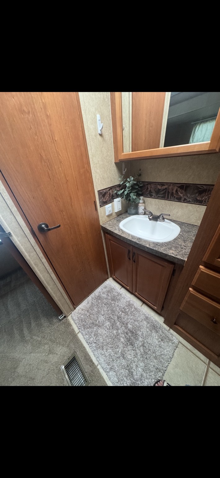 RV vanity, sink, mirror and surrounding floor after cleaning